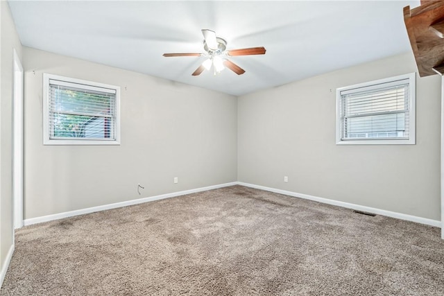 spare room featuring ceiling fan and carpet