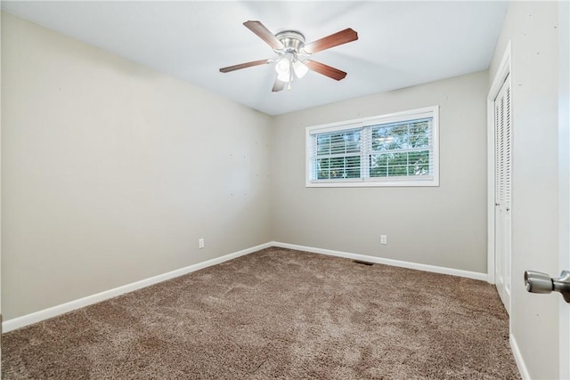 unfurnished bedroom with carpet flooring, ceiling fan, and a closet