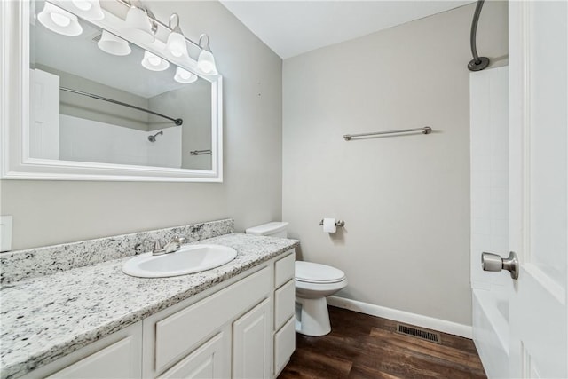 full bathroom featuring vanity, hardwood / wood-style flooring, toilet, and shower / bathtub combination