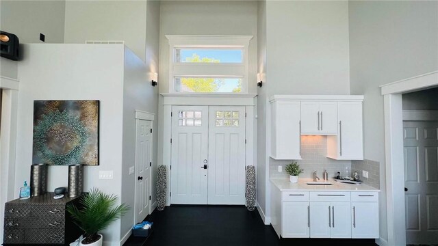 interior space with a high ceiling and a sink