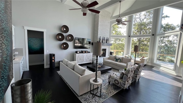 living room with dark hardwood / wood-style flooring, ceiling fan, and high vaulted ceiling