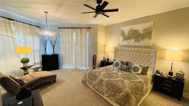 bedroom featuring ceiling fan with notable chandelier and light colored carpet