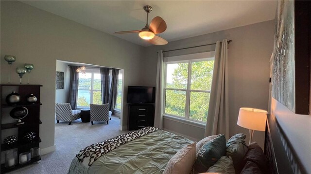 carpeted bedroom featuring multiple windows and ceiling fan