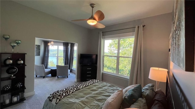 carpeted bedroom featuring a ceiling fan and multiple windows