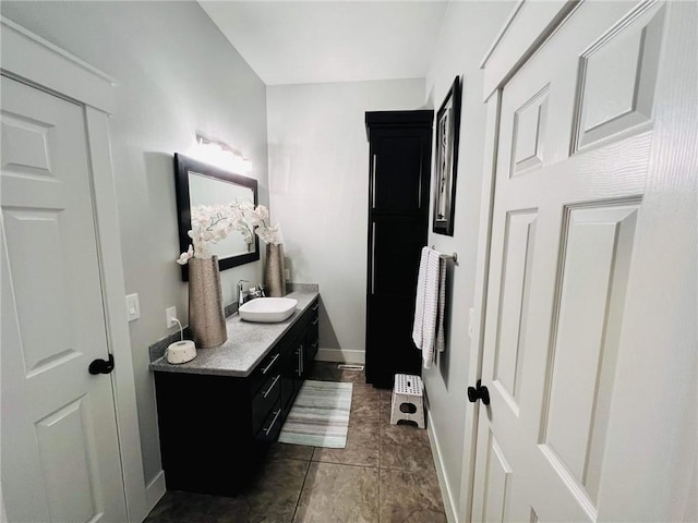 bathroom with vanity and baseboards