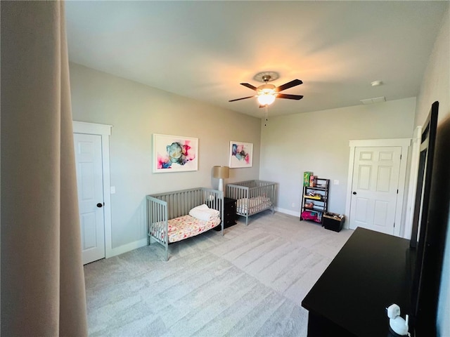 living area with carpet and ceiling fan