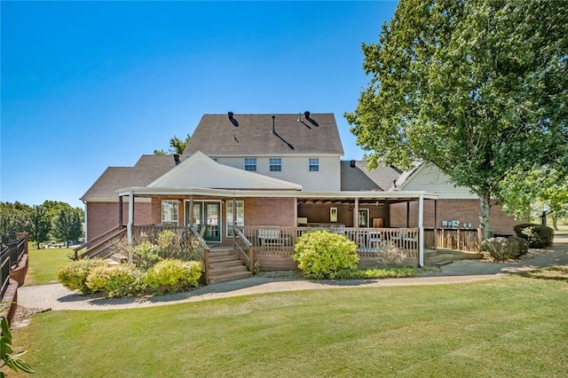 back of house featuring a lawn and covered porch