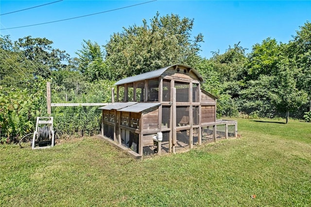 view of outdoor structure featuring a lawn