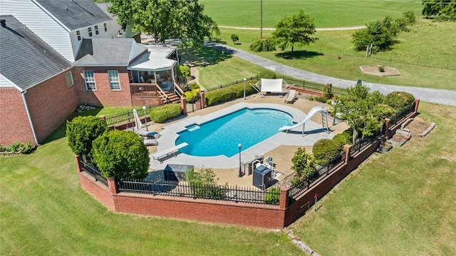 view of pool with a water slide, a diving board, and a patio