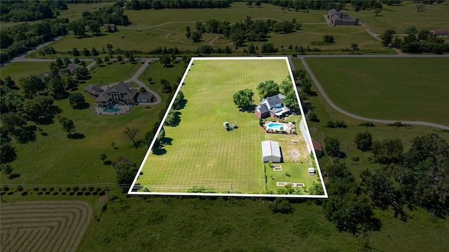 birds eye view of property with a rural view