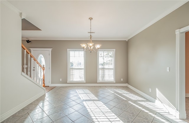 spare room with light tile patterned floors, crown molding, and a chandelier