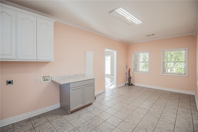 clothes washing area with cabinets, ornamental molding, washer hookup, light tile patterned floors, and electric dryer hookup