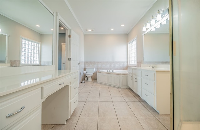 bathroom featuring a bathing tub, tile patterned flooring, vanity, toilet, and crown molding