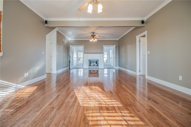 unfurnished living room featuring ceiling fan, ornamental molding, a fireplace, and light hardwood / wood-style floors