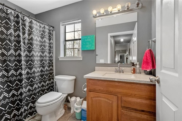 bathroom featuring vanity, toilet, and tile patterned flooring