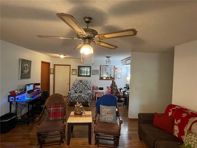 living room featuring ceiling fan, hardwood / wood-style floors, and a textured ceiling