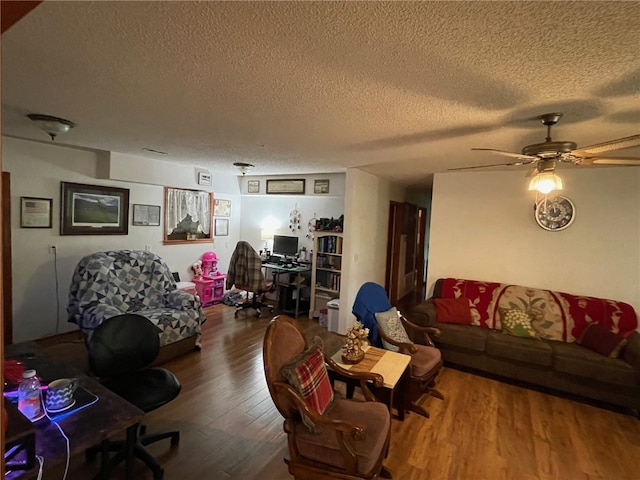 living room featuring a textured ceiling, ceiling fan, and hardwood / wood-style floors