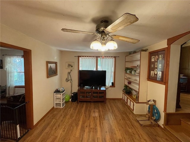 living room with hardwood / wood-style flooring and ceiling fan