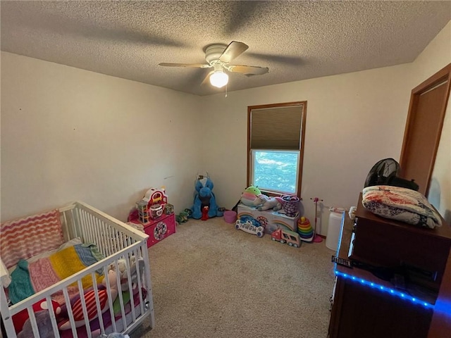 carpeted bedroom with ceiling fan and a textured ceiling