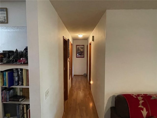 hallway with hardwood / wood-style floors