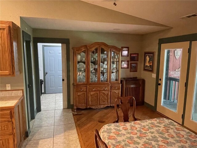 tiled dining space with lofted ceiling