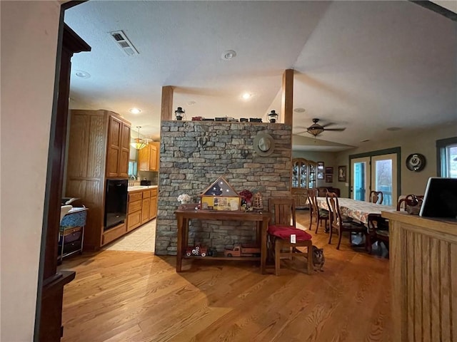 living room with light hardwood / wood-style flooring and ceiling fan