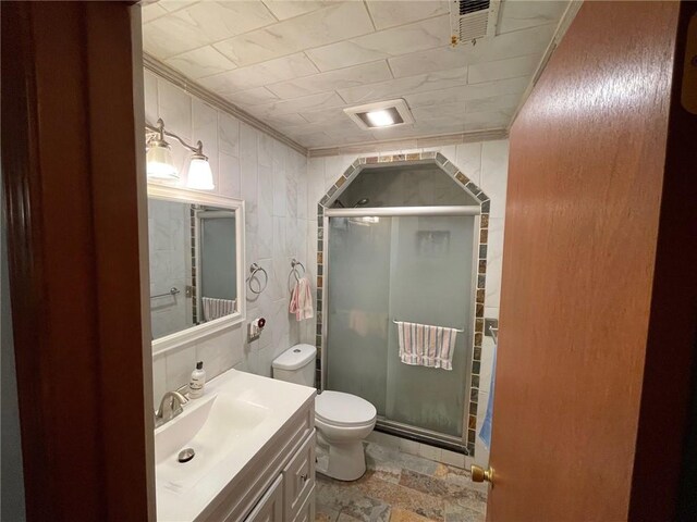 bathroom with vanity, ornamental molding, an enclosed shower, and toilet