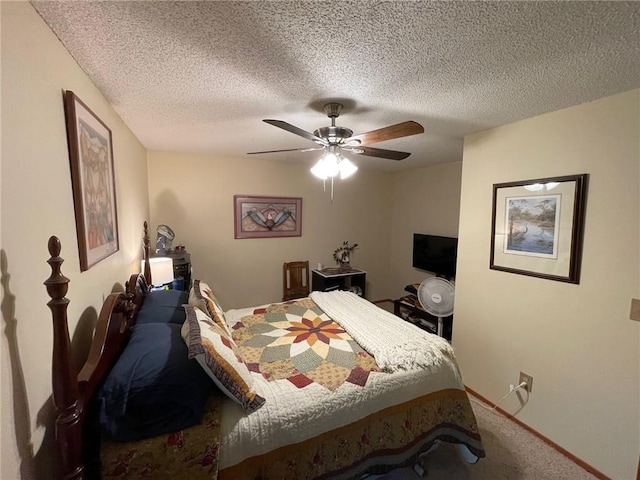 bedroom with ceiling fan, carpet, and a textured ceiling