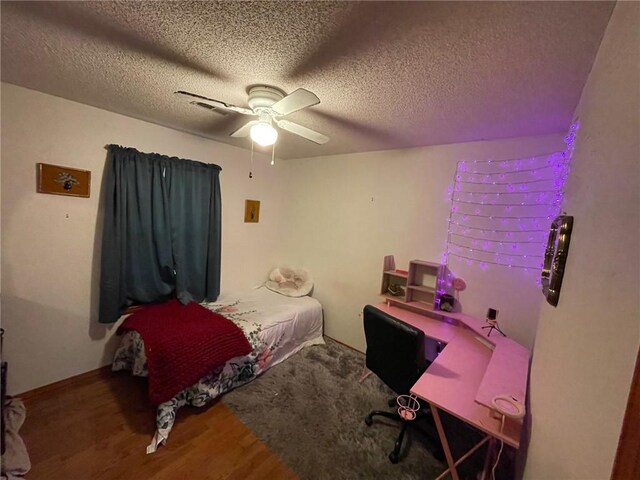 bedroom featuring a textured ceiling, ceiling fan, and hardwood / wood-style floors