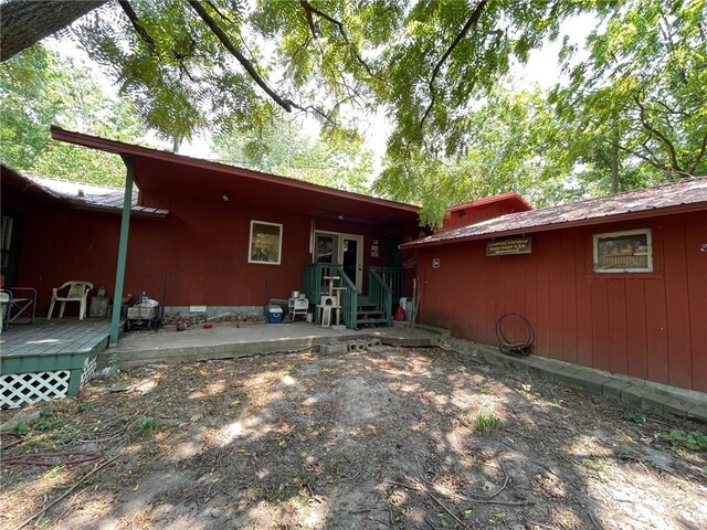 back of property featuring a wooden deck