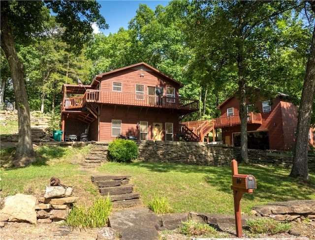 back of house featuring a deck and a lawn