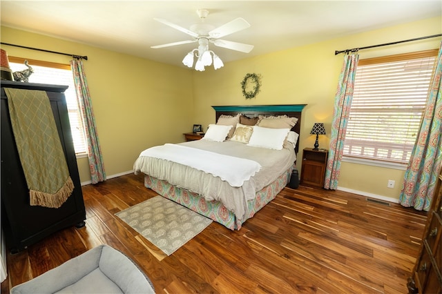 bedroom with ceiling fan and dark hardwood / wood-style flooring