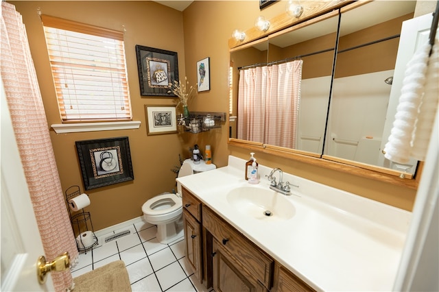 bathroom with tile patterned flooring, vanity, and toilet