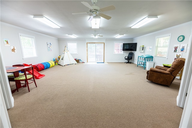 game room featuring ornamental molding, light carpet, and ceiling fan