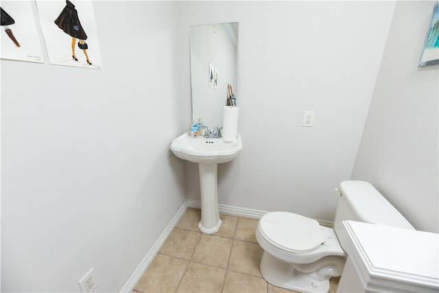 bathroom with toilet and tile patterned flooring