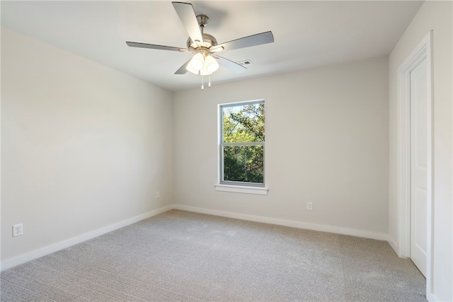 spare room with ceiling fan and carpet flooring