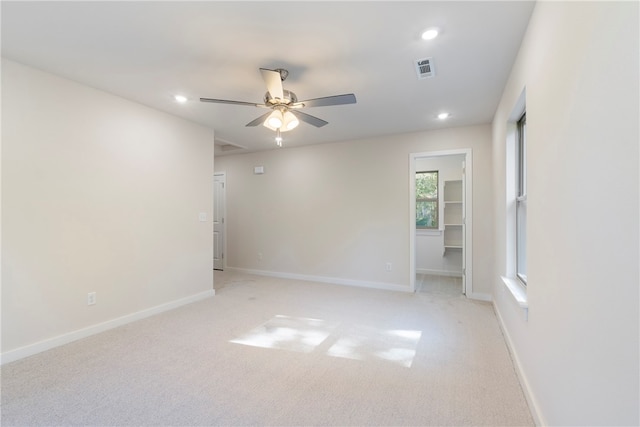 empty room featuring light carpet and ceiling fan