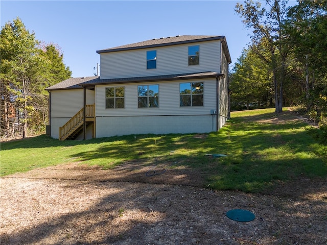 rear view of property with a lawn