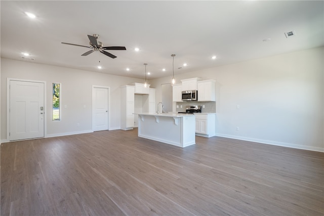 unfurnished living room with light hardwood / wood-style flooring and ceiling fan