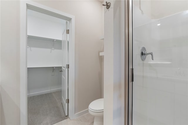 bathroom with an enclosed shower and toilet