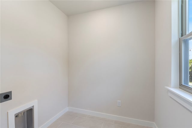 clothes washing area featuring light tile patterned floors and hookup for an electric dryer