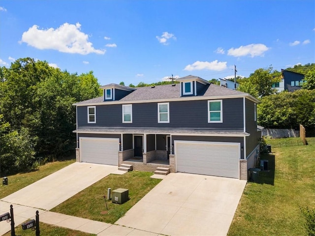 view of front of house featuring a garage and a front lawn