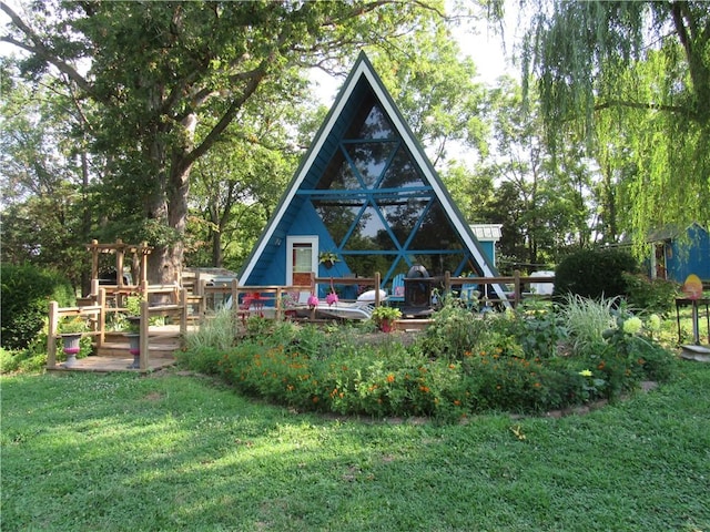 rear view of property featuring a yard