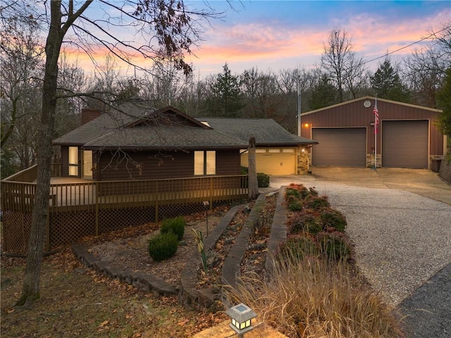 view of front of home featuring an outbuilding, a deck, and a garage