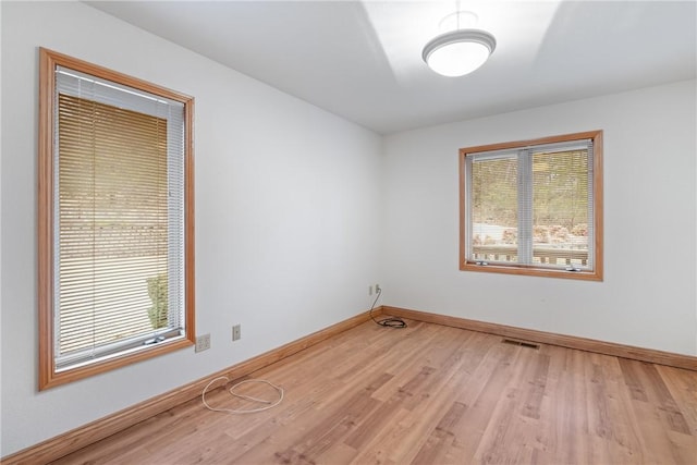 spare room with light wood-type flooring