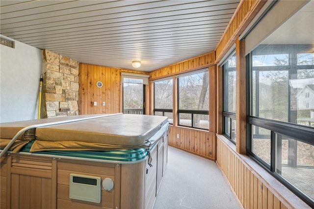 sunroom with a hot tub