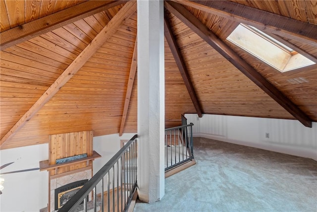 bonus room featuring carpet flooring, lofted ceiling with skylight, and wood ceiling