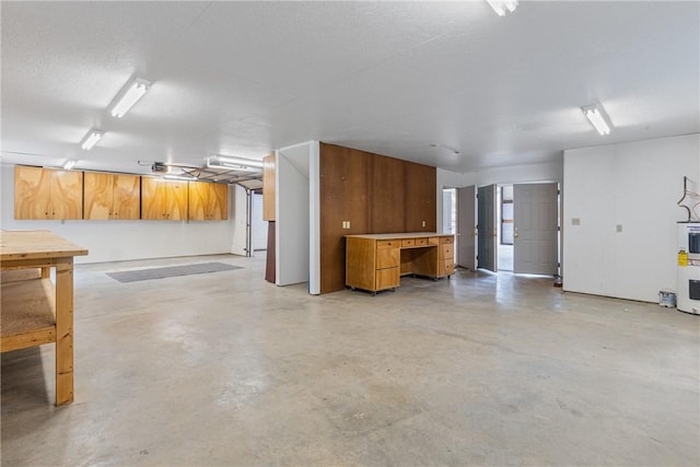 garage with electric water heater and a garage door opener