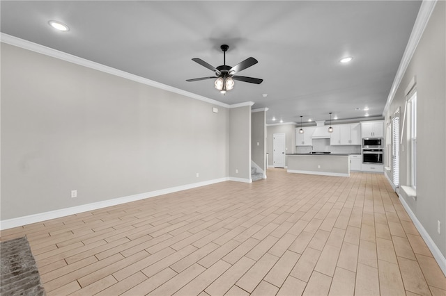 unfurnished living room featuring ceiling fan and crown molding