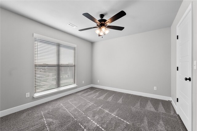 spare room featuring carpet flooring and ceiling fan